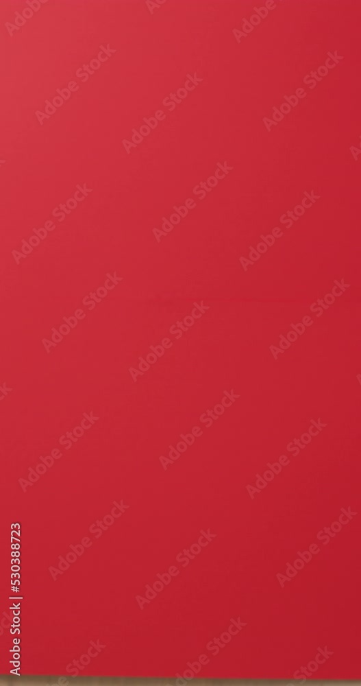 Vertical video of santa claus hand with smartphone over red background Vertical video of santa claus hand with smartphone over red background