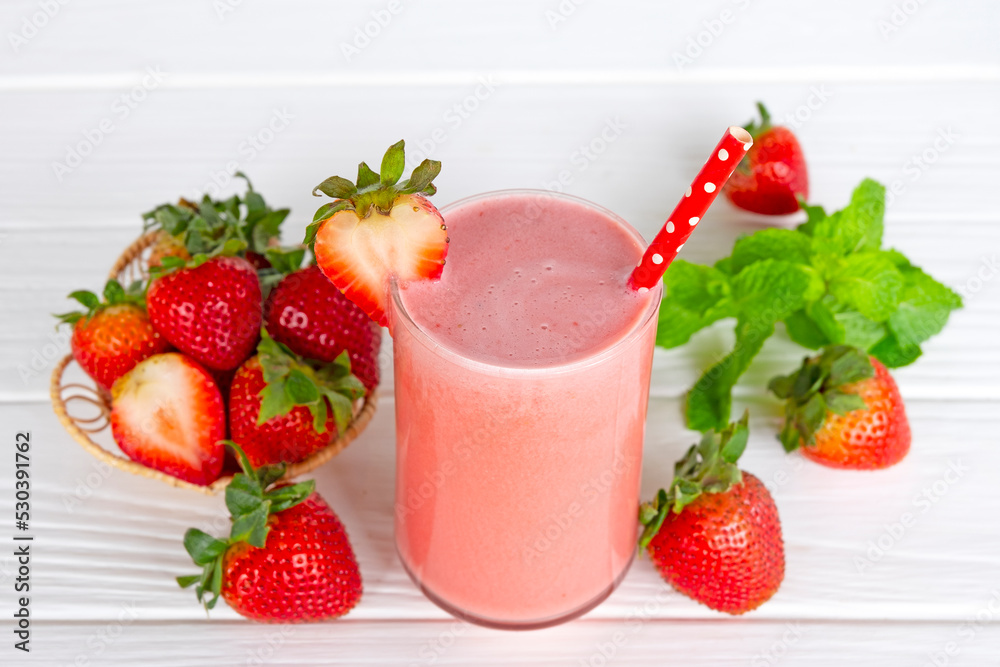 Strawberry yogurt fruit juice smoothie pink colorful fruit juice milkshake blend beverage healthy high protein the taste yummy In glass drink episode morning on white wood background.