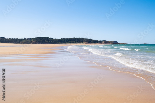 Large sandy beach in the town of  Sables d or les pins  in Brittany at low tide in summer
