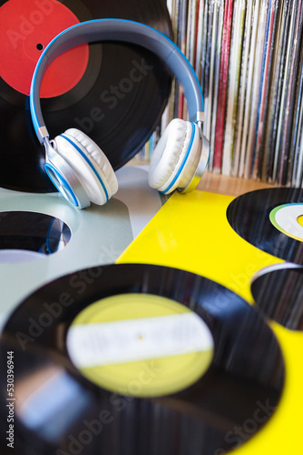 Headphones and several messed up vinyl records. Concept of listening to music.