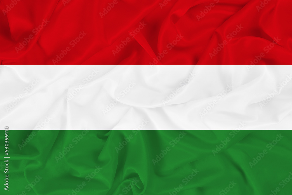 Beautiful national flag of Hungary on wavy fabric background, red white green Hungarian flag symbol