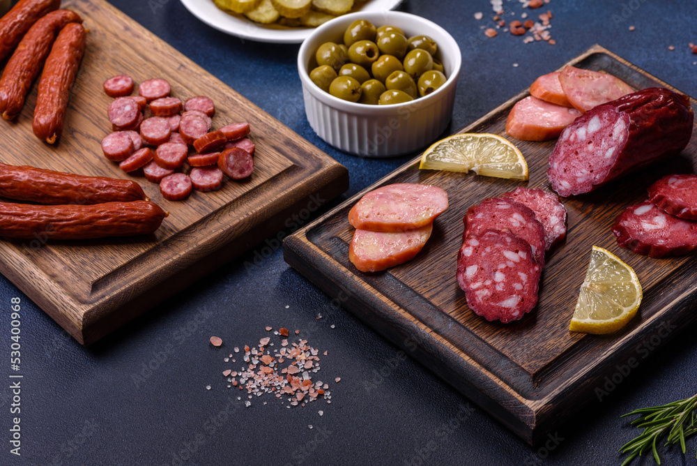 Delicious fresh smoked sausages cut with slices on a wooden cutting board Delicious fresh smoked sausages cut with slices on a wooden cutting board