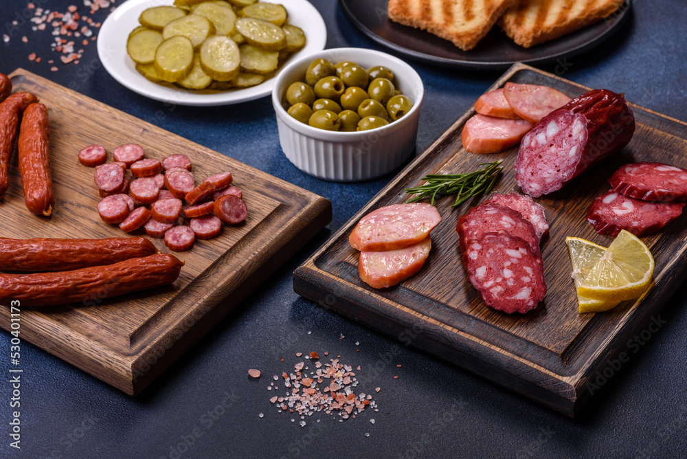 Delicious fresh smoked sausages cut with slices on a wooden cutting board Delicious fresh smoked sausages cut with slices on a wooden cutting board