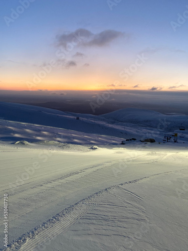 Ski resort at sunset. Nothern winter landscape. ski corduroy.