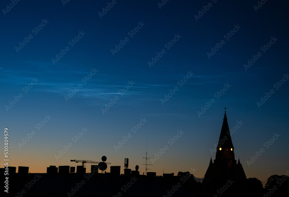noctilucent clouds over stockholm city skyline