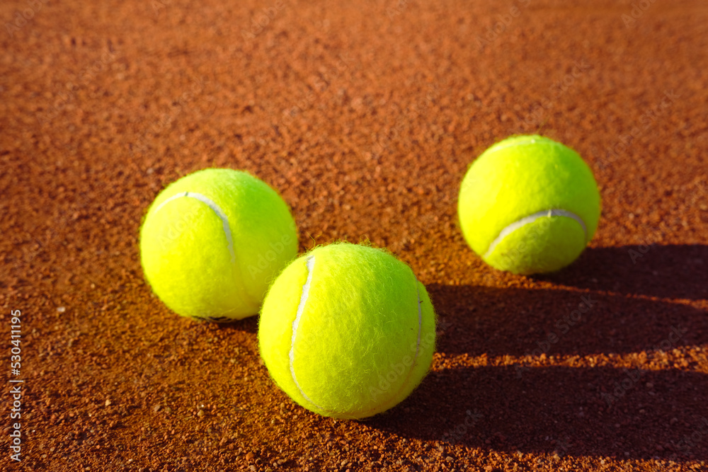 Tennis balls on a clay court. training Sunny summer