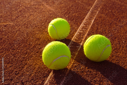 Tennis balls on a clay court. training Sunny summer © aksol