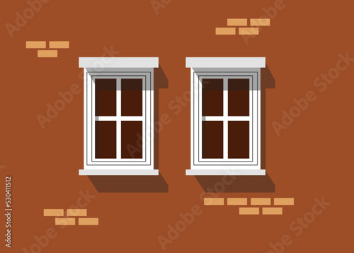 Zwei Fenster in einem Backsteinhaus. 