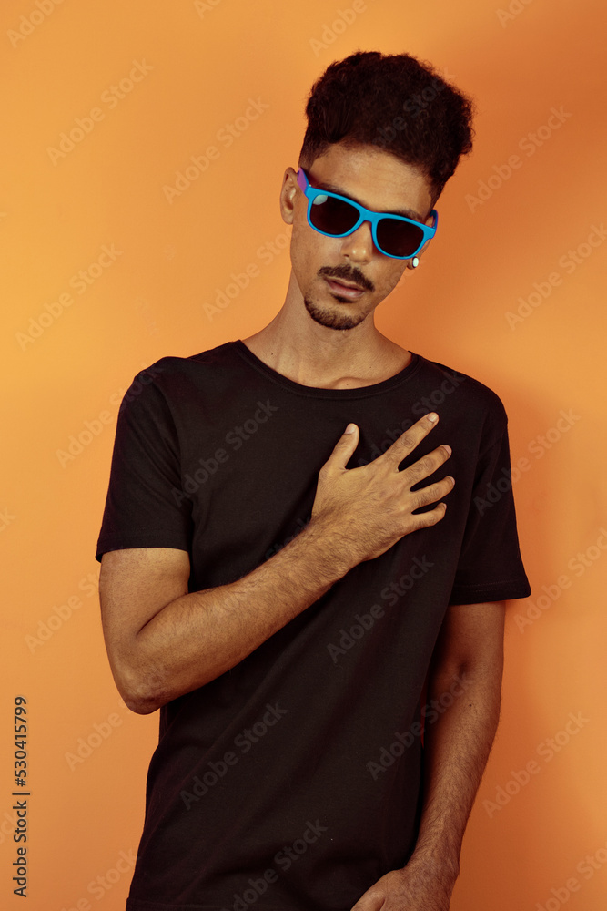Portrait of a friendly-looking african american man with afro hairstyle smiling isolated on orange copy space Portrait of a friendly-looking african american man with afro hairstyle smiling isolated on orange copy space