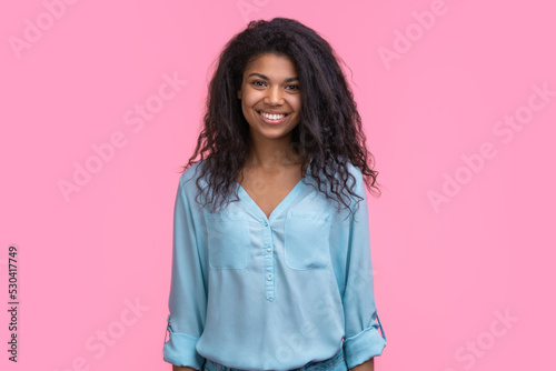 Portrait of young attractive woman isolated over pastel pink background