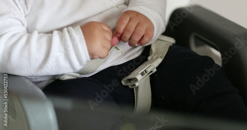Baby todlder fastened belt on highchair, infan thands holding belt