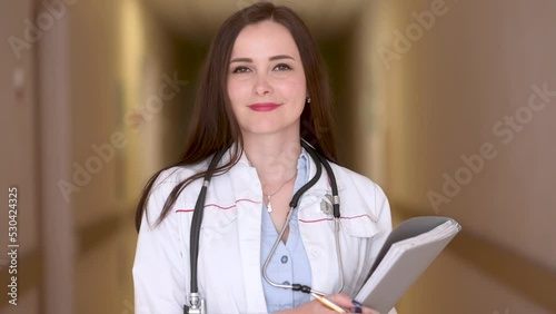 Portrait of Confident Female Doctor In medical Uniform with clipboard in hospital. Health care and people.	