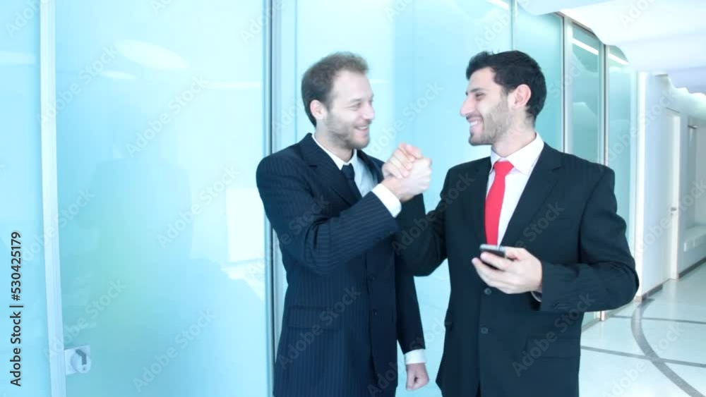 Two businessman hear good news Two businessman hear good news