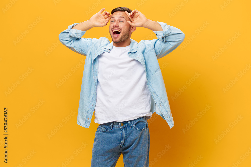 Excited happy tanned handsome man in blue basic t-shirt have cool idea touch head posing isolated on orange yellow studio background. Copy space Banner Mockup. People emotions Lifestyle concept Excited happy tanned handsome man in blue basic t-shirt have cool idea touch head posing isolated on orange yellow studio background. Copy space Banner Mockup. People emotions Lifestyle concept