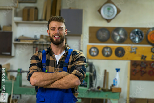 Fotografija Portrait of smiley handsome carpenter at his workplace