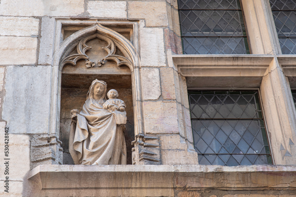 Fototapeta premium Religious statue on the outside of a church in the city centre of Dijon in France