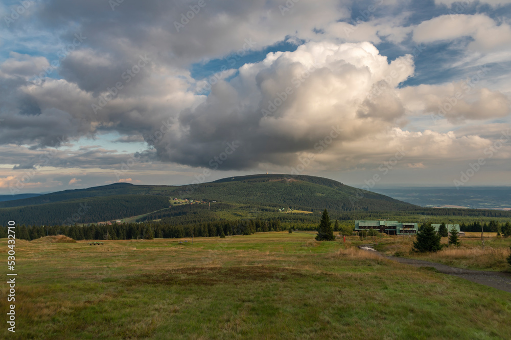 Cerna hill in summer color evening with some clouds in Krkonose