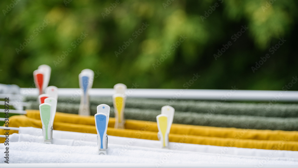 closeup of plastic clothespin on drying rack outdoors