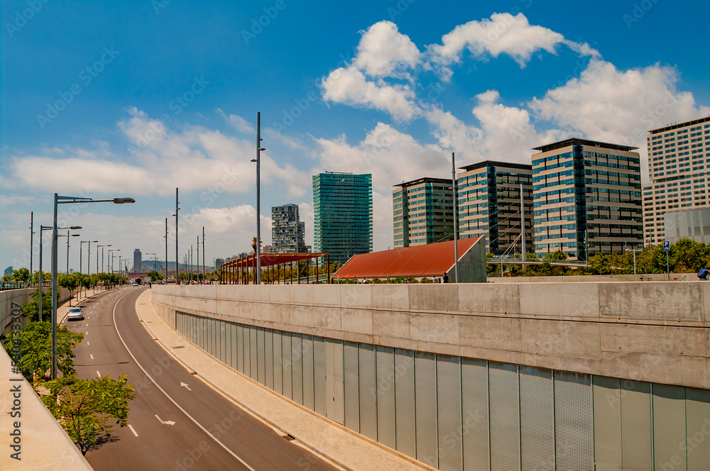 Obraz premium Barcelona, Spain – July 15, 2012: Modern architecture at new districts of Barcelona at summer sunny hot day and blue sky during warm sunset colors.