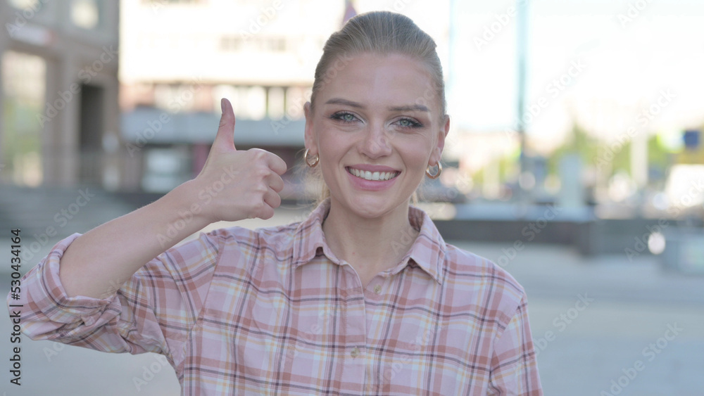 Thumbs Up By Young Woman Standing Outdoor
