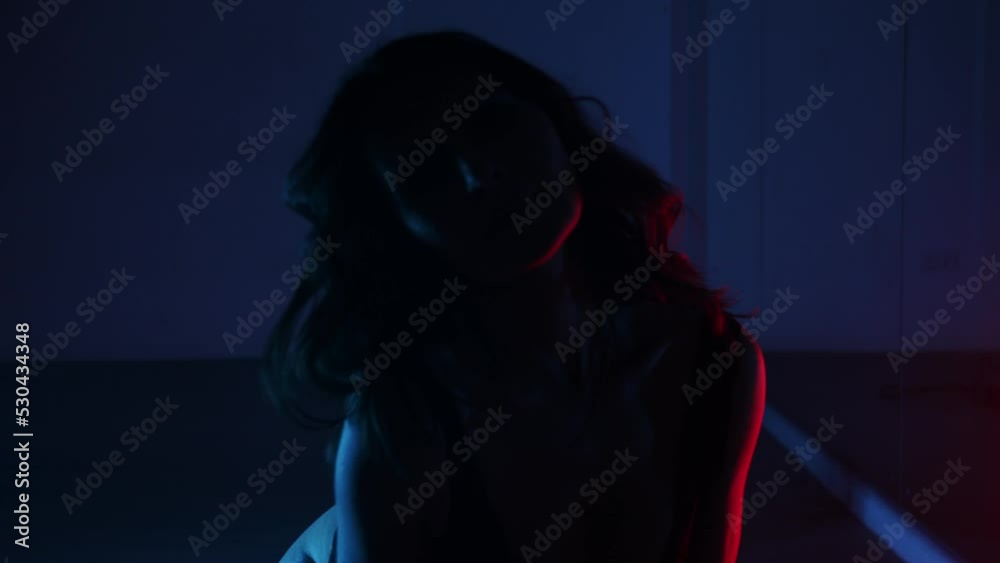 Adult brunette woman in black underwear dancing on the floor in the dark Adult brunette woman in black underwear dancing on the floor in the dark
