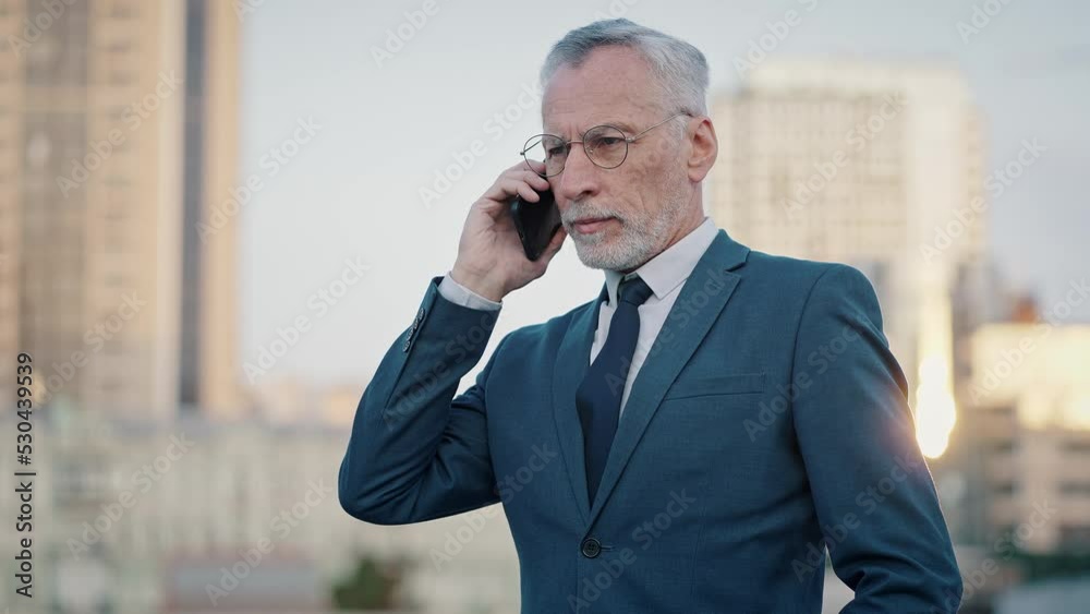 Senior businessman calls to client by phone checking time Senior businessman calls to client by phone checking time