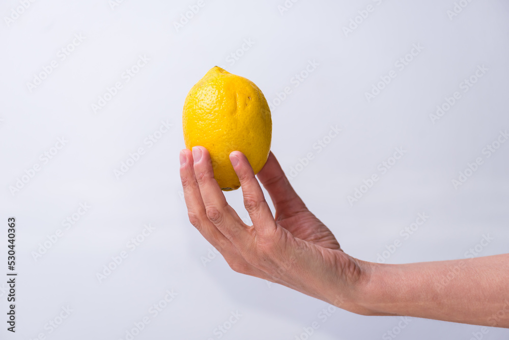 delicate hand with a lemon, yellow, fruits and vegetables healthy living, lifestyle delicate hand with a lemon, yellow, fruits and vegetables healthy living, lifestyle