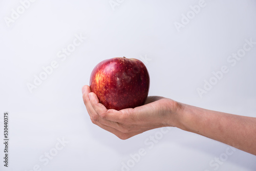 hand holding a red apple, fruits and vegetables, healthy living, lifestyle