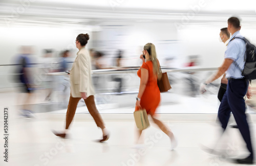 Blurred image of people near the escalators in the subway