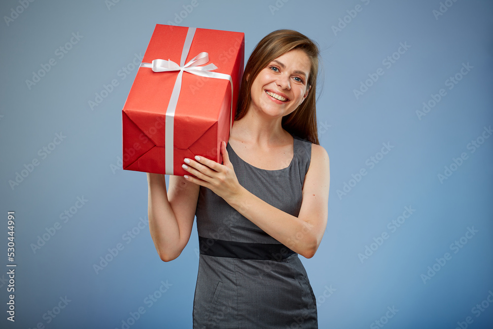 Happy woman holding red gift box on shoulder, isolated portrait. Happy woman holding red gift box on shoulder, isolated portrait.