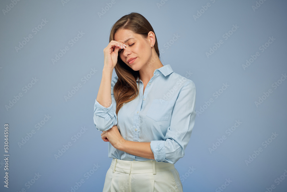 Portrait of woman with headache touching her head. Isolated female portrait on blue. Portrait of woman with headache touching her head. Isolated female portrait on blue.