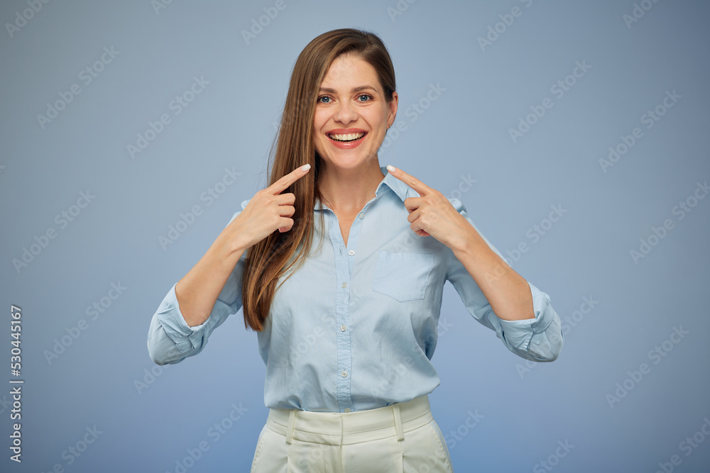 Woman pointing at toothy smile with white teeth. Isolated portrait on blue. Woman pointing at toothy smile with white teeth. Isolated portrait on blue.