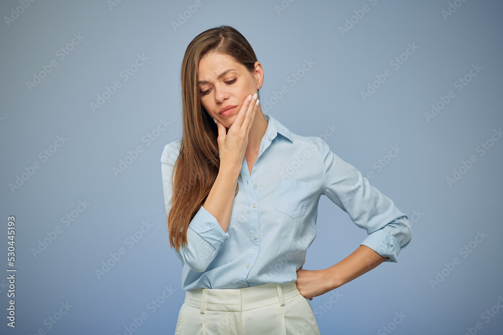 Young woman with toothache isolated portrait on blue. Girl touching cheek. Young woman with toothache isolated portrait on blue. Girl touching cheek.