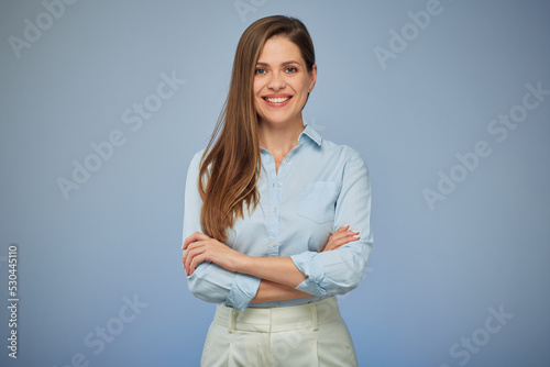 Smiling business woman in blue shirt standing with arms crossed. isolated portrait.