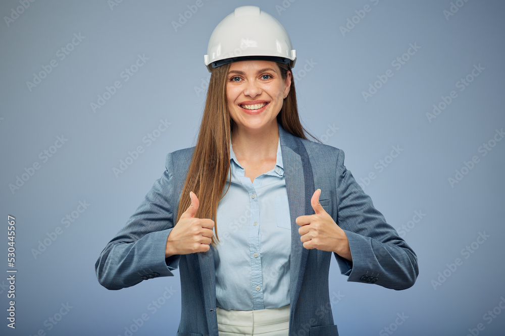 Smiling woman builder in white safety industrial helmet. Isolated female portrait with thumbs up. Smiling woman builder in white safety industrial helmet. Isolated female portrait with thumbs up.