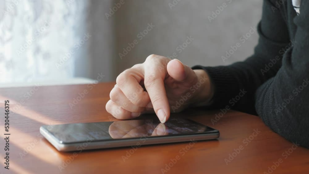 The girl flips through the video page on her phone. A woman is watching a video on the Internet. The girl flips through the video page on her phone. A woman is watching a video on the Internet.