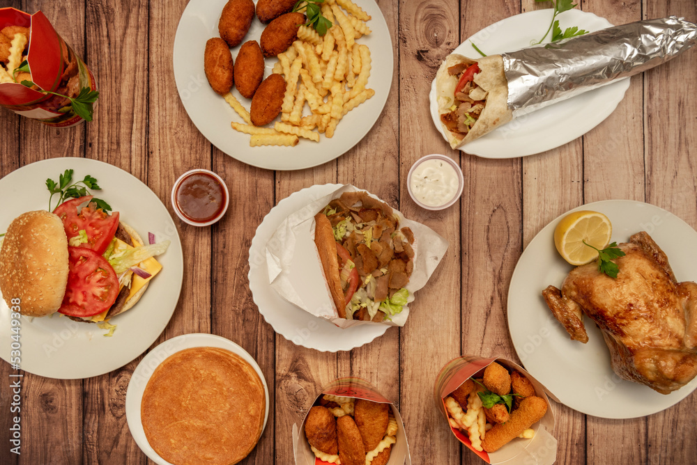 Set of dishes of a kebab restaurant with durum, lamb kebab sandwich, french fries and a burger with cheese and tomato Set of dishes of a kebab restaurant with durum, lamb kebab sandwich, french fries and a burger with cheese and tomato
