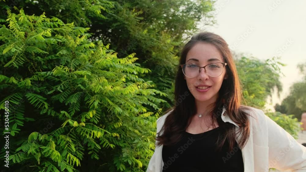 Beautiful girl in green shorts and a white shirt poses on the river bank near a green bush. Looking at the camera
Beautiful girl in green shorts and a white shirt poses on the river bank near a green bush. Looking at the camera