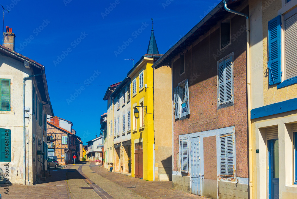 Picturesque street view of small authentic French township of Romenay overlooking traditional wooden timber-framed houses on sunny summer day