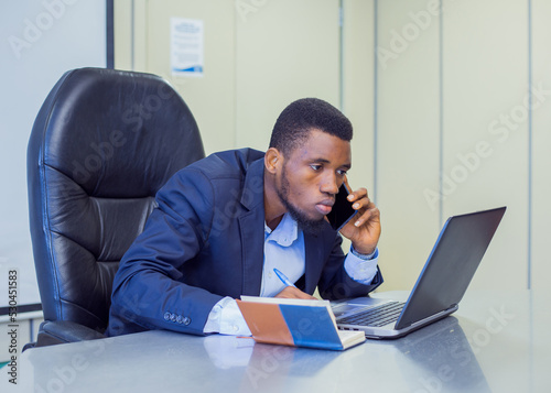 African young manager in the board room with a laptop