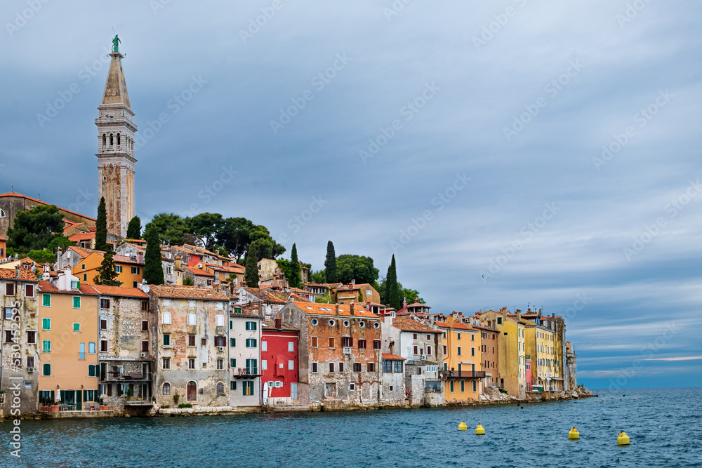 Stormy sky provides an artistic canvas for the many hued houses of Rovinj