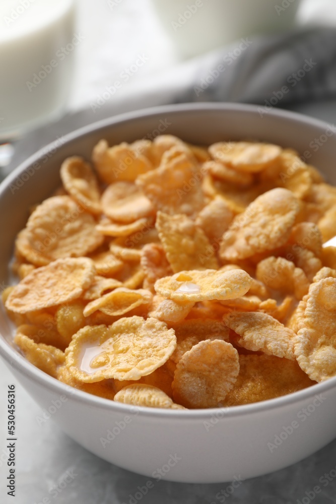 Tasty cornflakes with milk in bowl on table, closeup Tasty cornflakes with milk in bowl on table, closeup