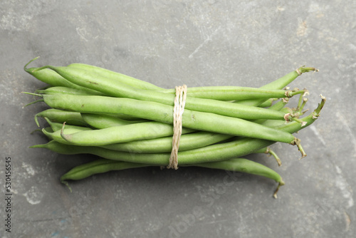 Fresh green beans on grey table  top view