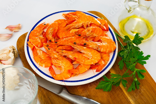 Dish of Mediterranean cuisine - baked in oven langoustine served with lemon
