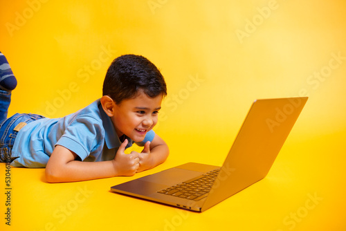 smiling boy looking at laptop