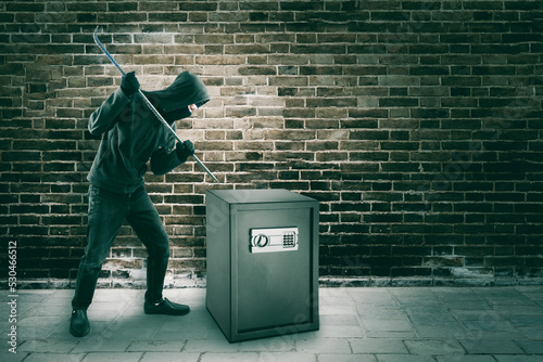 Fényképezés Male robber using a crowbar to breaking a vault