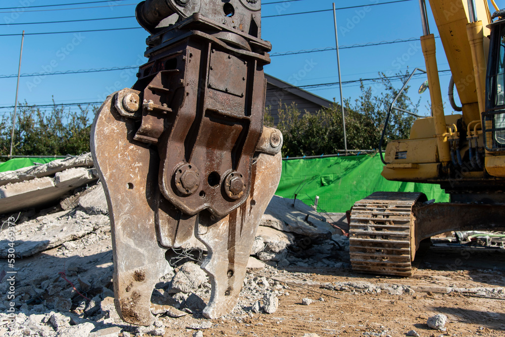 Fototapeta premium Large nibbler for demolition machine attachment, demolition work site, construction industry