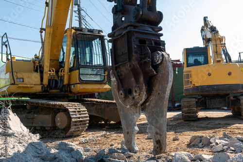 Large nibbler for demolition machine attachment, demolition work site, construction industry photo