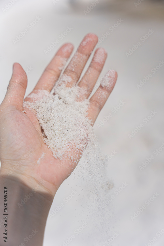 Fototapeta premium Hand Holding White Sand