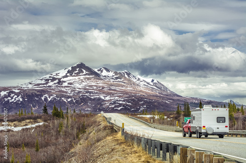 Trailer drives on the road to the mountain in Alaska